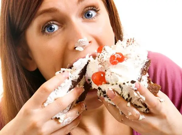 Woman-Eating-Cake-with-Two-Hands